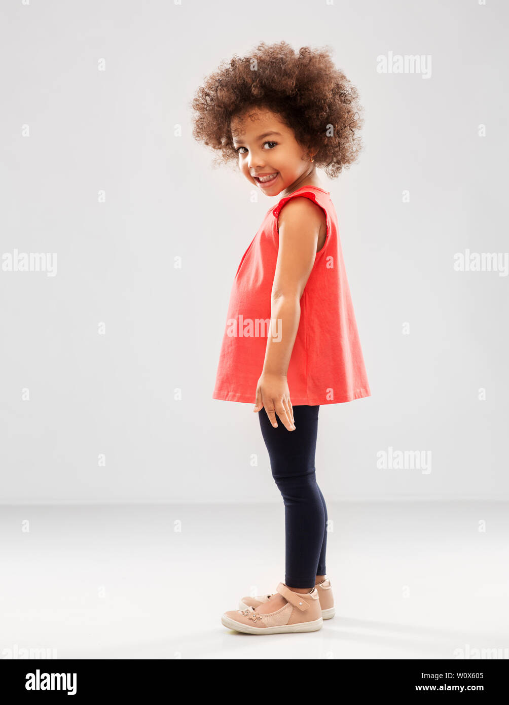 happy little african american girl over grey Stock Photo - Alamy