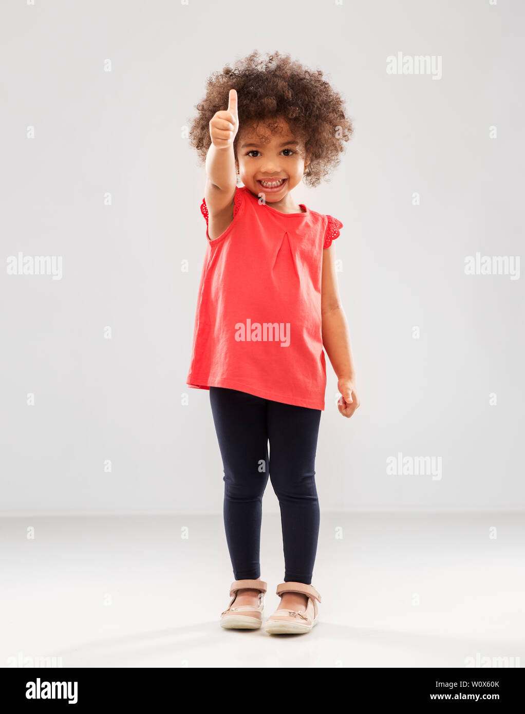 little african american girl showing thumbs up Stock Photo - Alamy