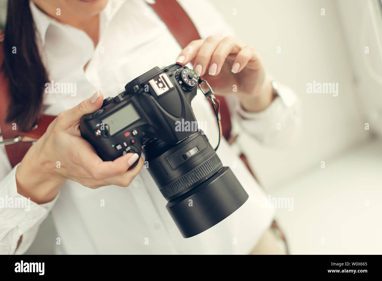 Pretty woman is a professional photographer with dslr camera Stock ...