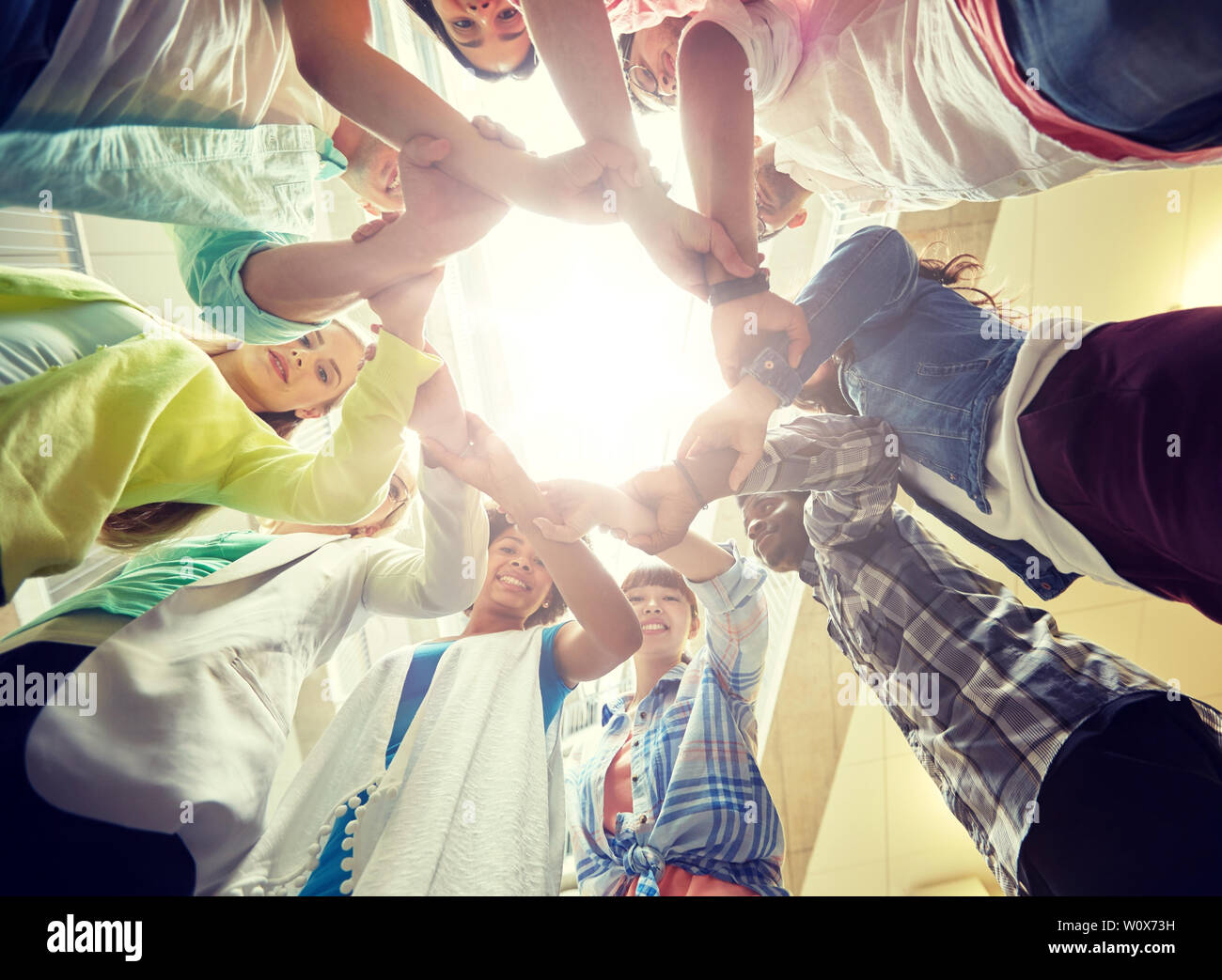group of international students holding hands Stock Photo - Alamy