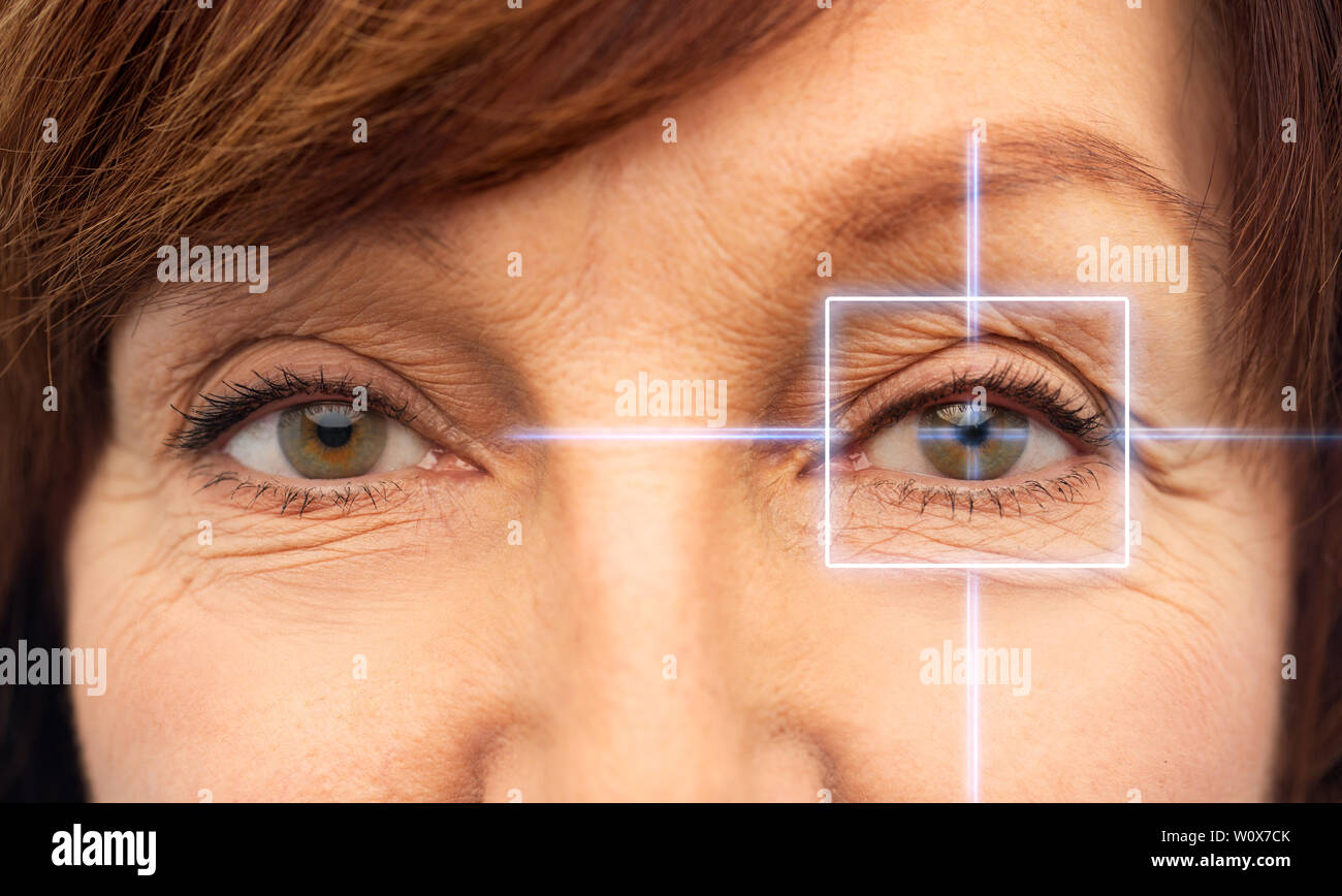 close up of senior woman eyes with laser light Stock Photo