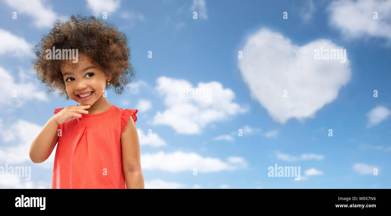 happy little african american girl over blue sky Stock Photo - Alamy