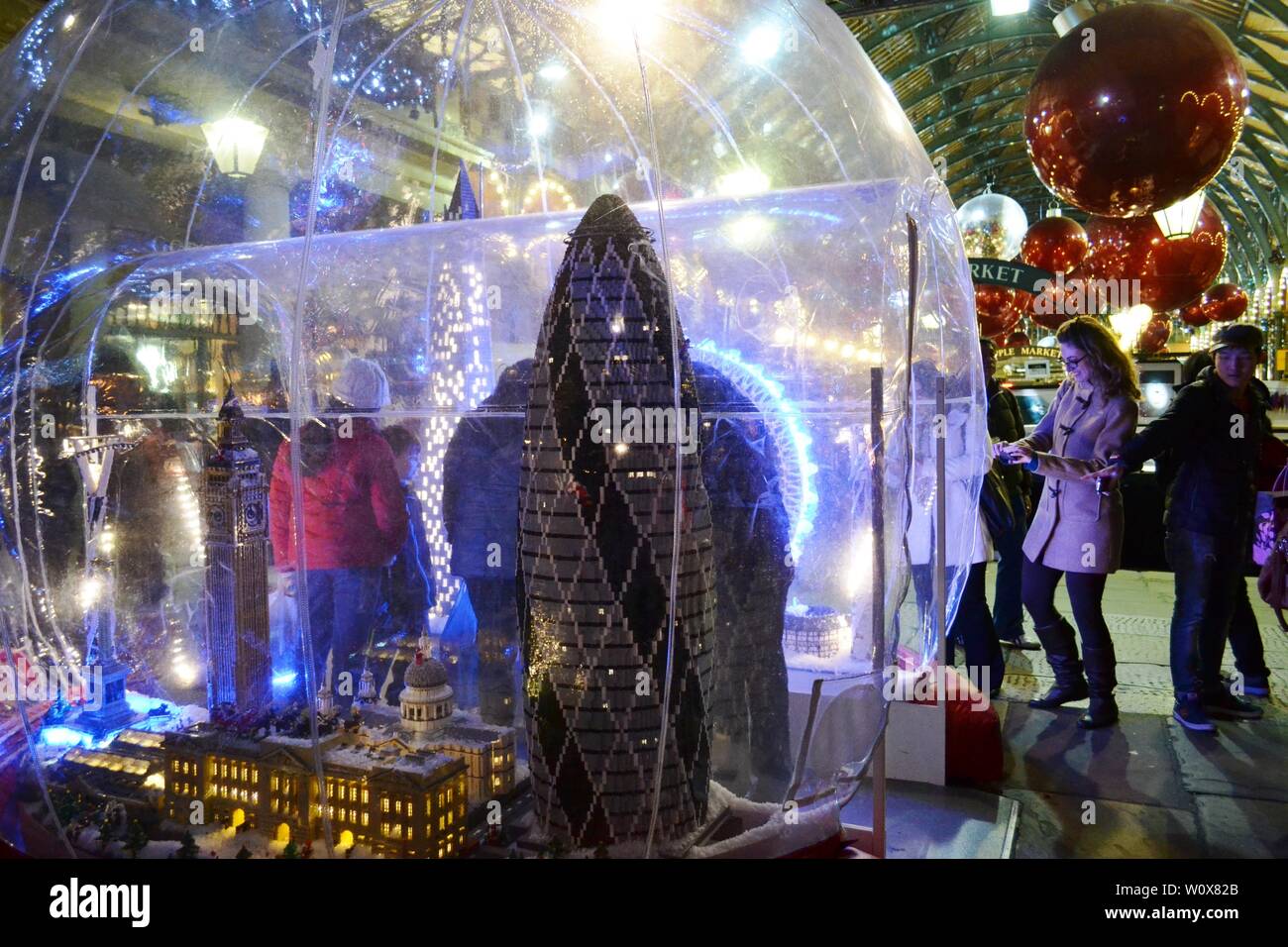 London/UK - November 27, 2013: People enjoying models of London famous landmarks exposed in the Covent Garden Apple market decorated for Christmas. Stock Photo