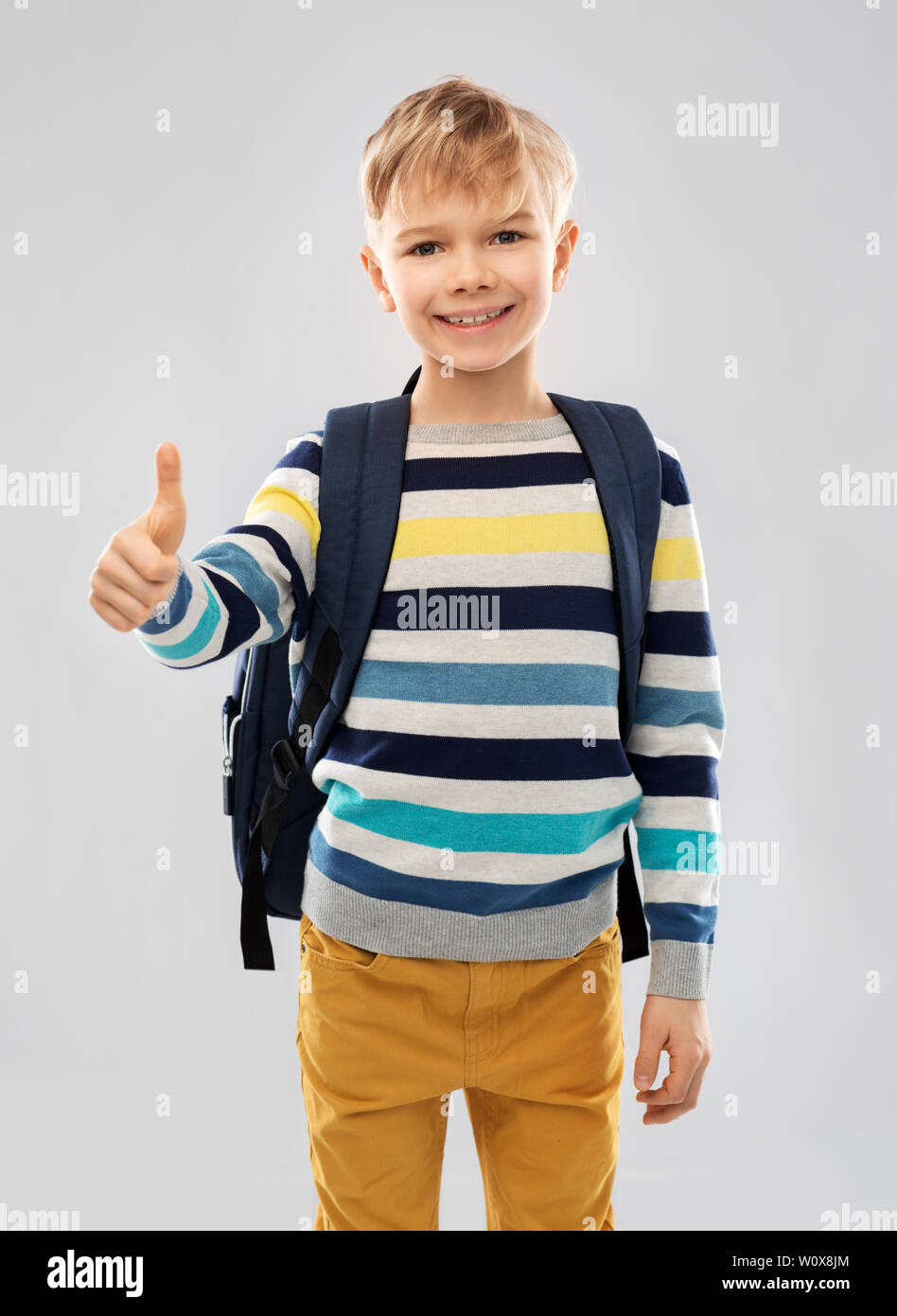 student boy with school bag showing thumbs up Stock Photo - Alamy