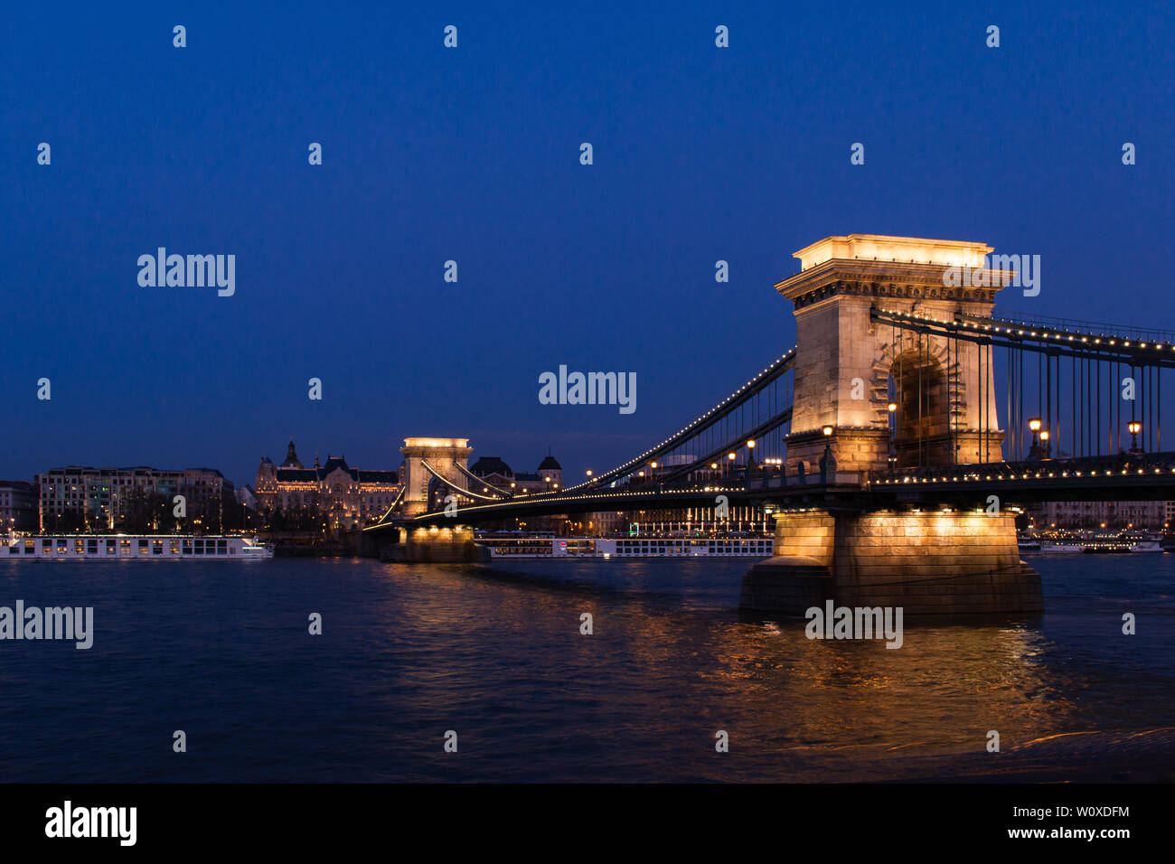 Szechenyi Chain Bridge illuminated at night over the Danube River in Budapest Stock Photo