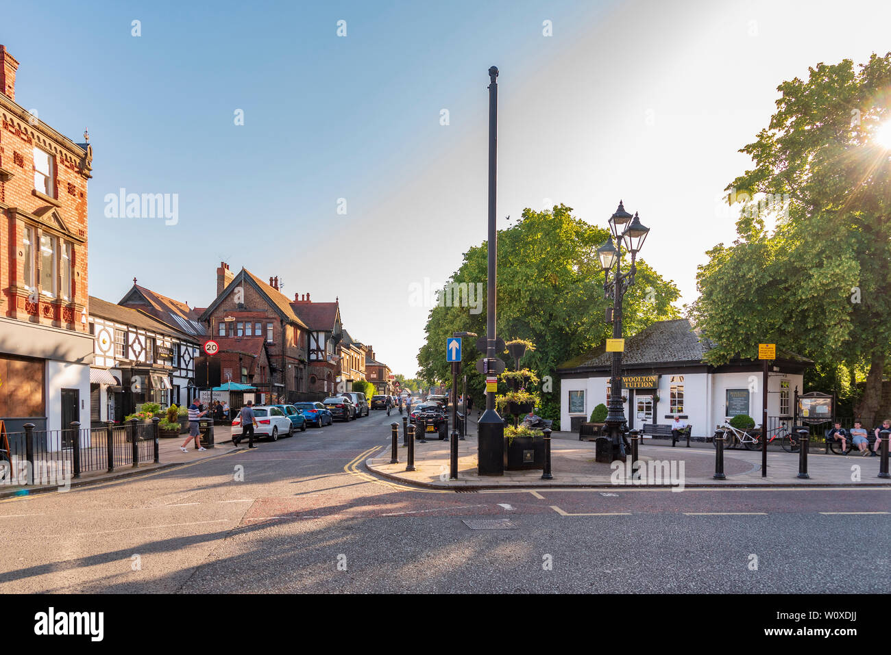 The centre of Woolton village Liverpool on a summers evening wit the former public convenience turned into offices. Stock Photo