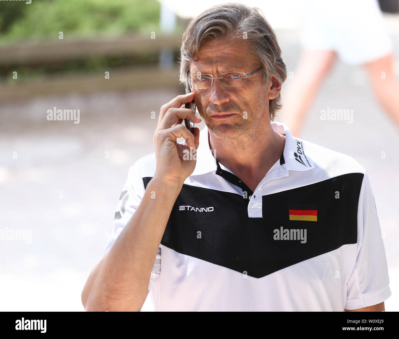 Hamburg, Germany. 28th June, 2019. Beach volleyball, World Cup, in the Rothenbaum Stadium: Rene Hecht, President of the German Volleyball Association, on the phone on the stairs to the Center Court. Credit: Christian Charisius/dpa/Alamy Live News Stock Photo
