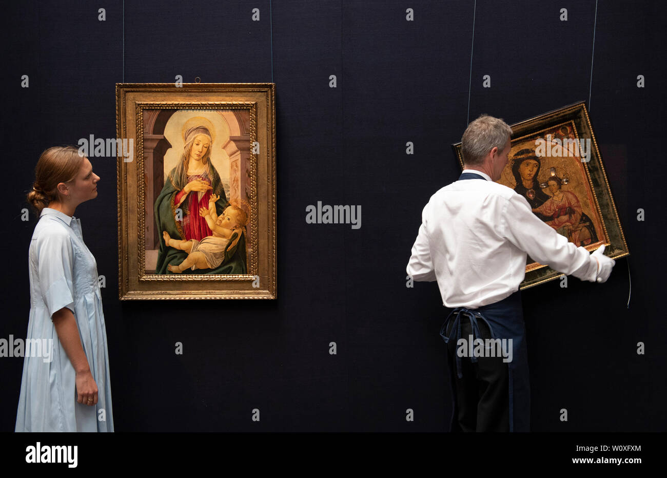 Sotheby’s, London, UK. 28th June 2019. Major works by Botticelli, Brueghel, Rubens and landscapes by Gainsborough, Turner and Constable in one of the most valuable Old Masters sales ever staged, to take place on 3 July 2019. Image (l to r): Sandro Bottocelli and Studio, Madonna and Child, seated before a classical window. Estimate £1,200,000-2,000,000; Earliest painting in the sale, around mid-1230s, Third Master of Anagi, The Madonna and Child, two angels in the spandrels above. Estimate £200,000-300,000. Credit: Malcolm Park/Alamy Live News. Stock Photo