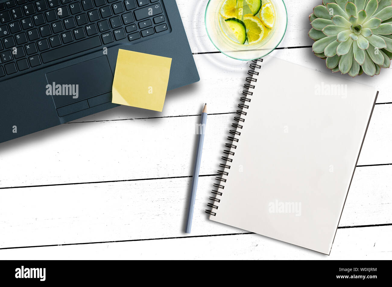 top view of office desk with laptop computer, notepad, pen and succulent plant Stock Photo