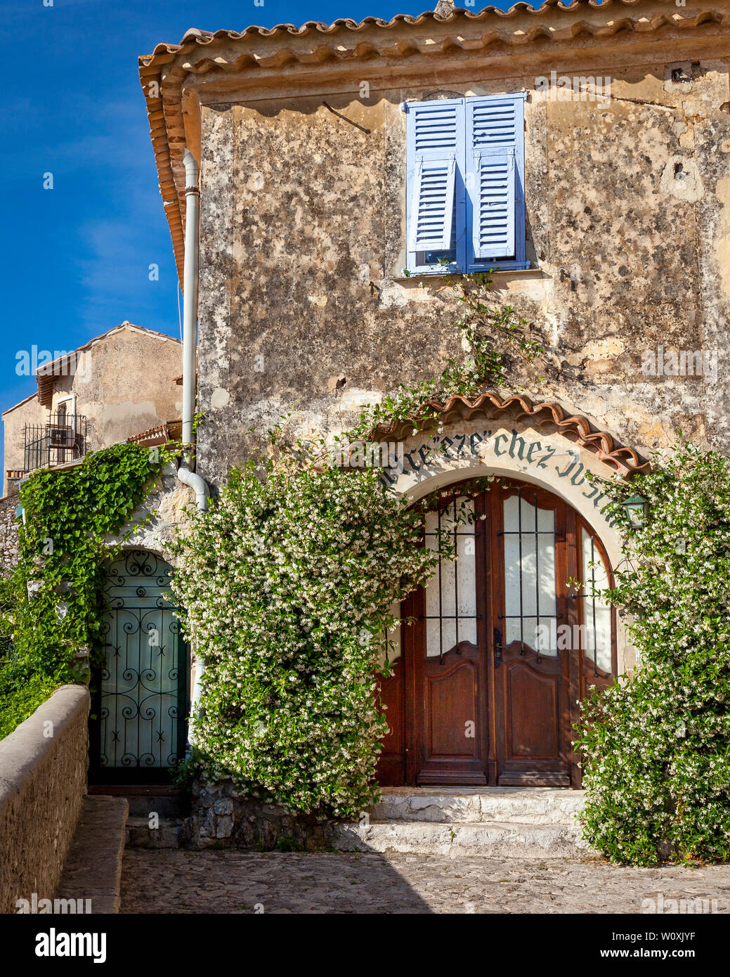 Jasmine framed arched doorway in medieval village of Eze, Provence, France Stock Photo