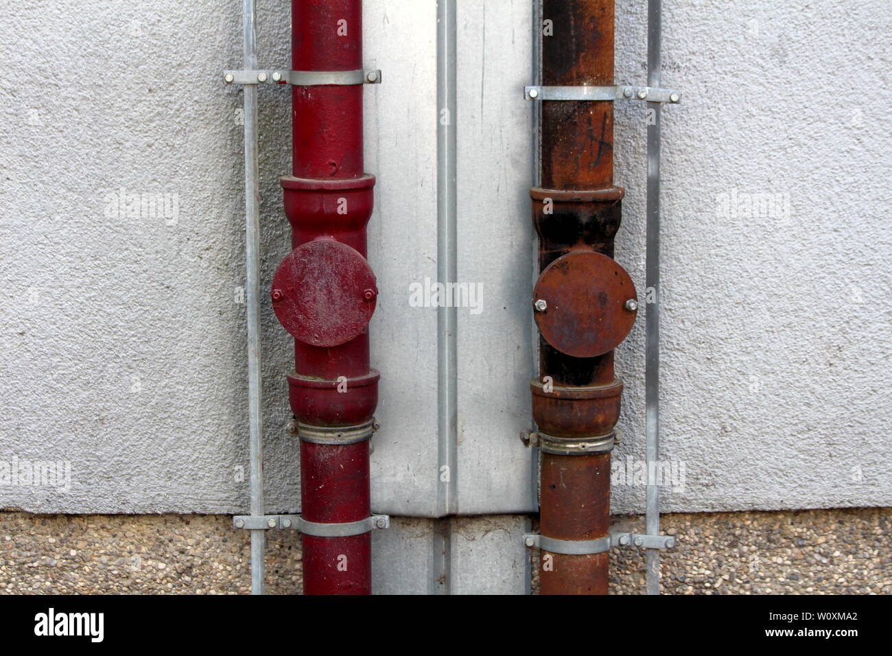 Two strong rusted metal gutter rainfall pipes connected to lightning ...