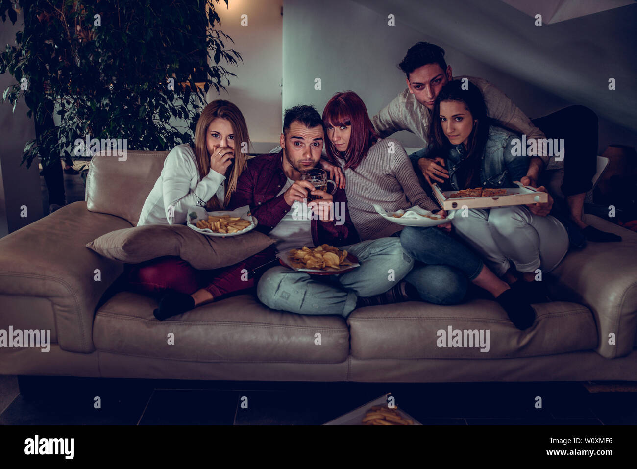 Group of happy friends bonding at home Young adults having party and doing various activities