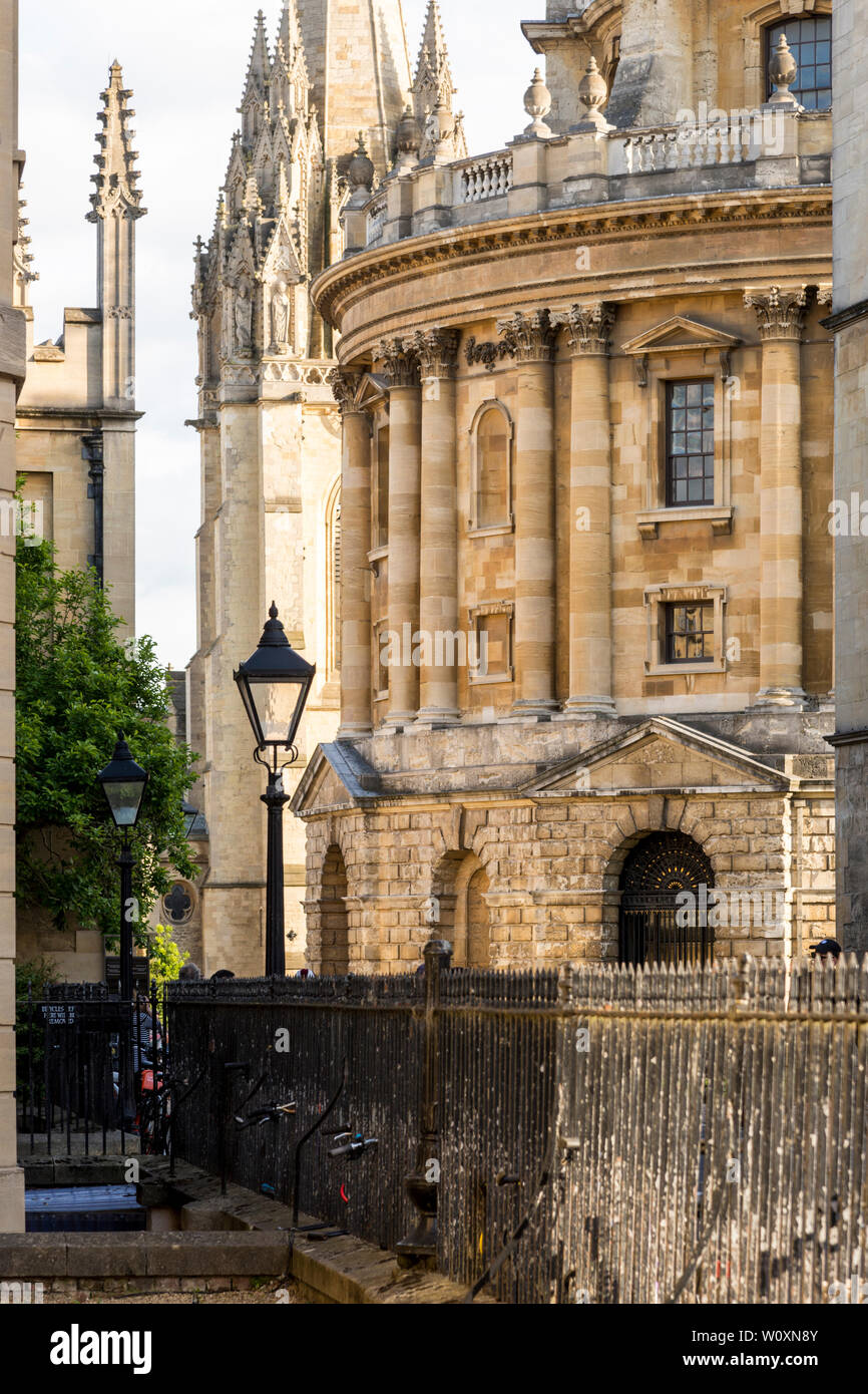 A beautiful summer's evening in the famous university town of Oxford. A view of the Radcliffe Camera including a silhouetted traditional street lamp. Stock Photo