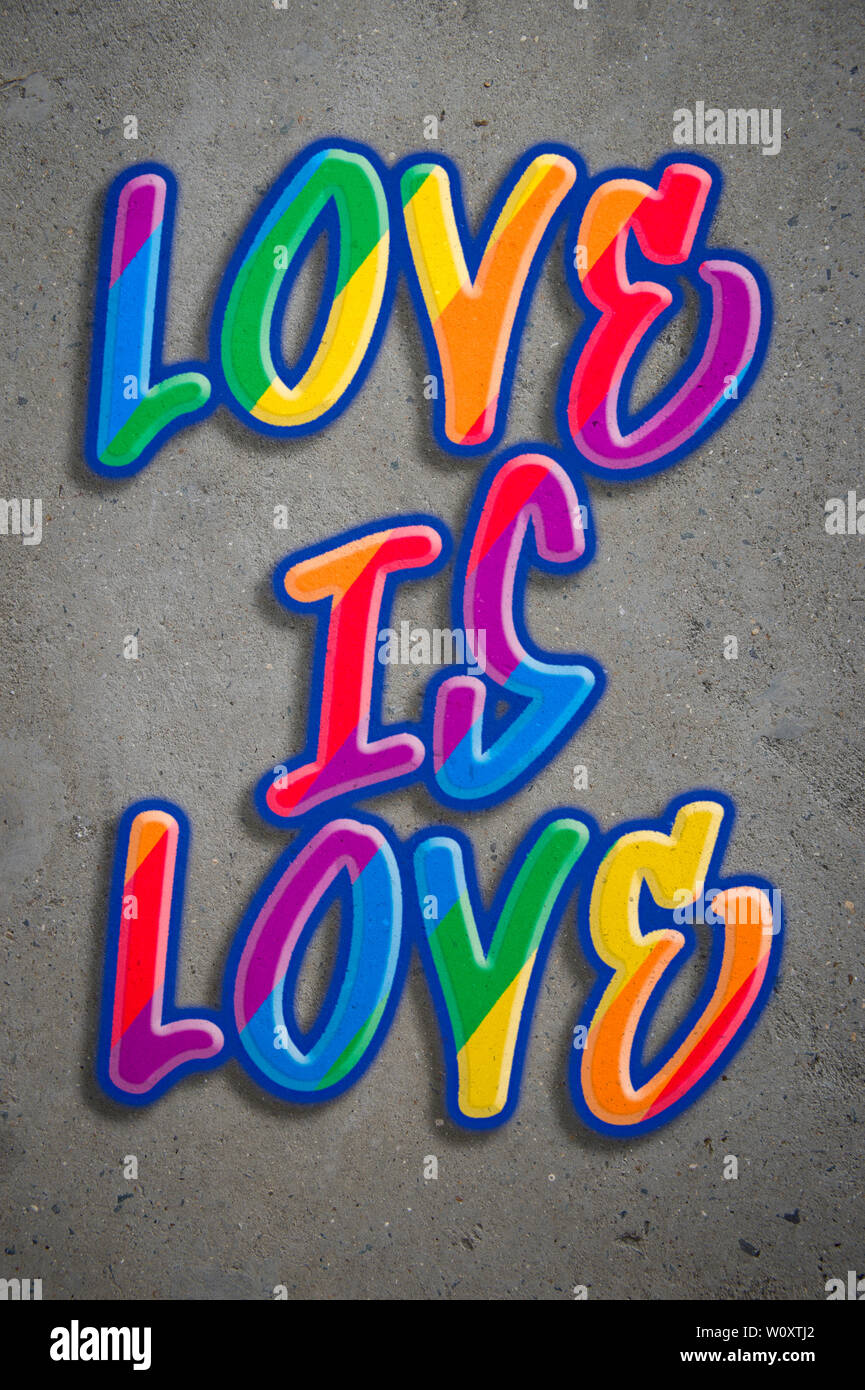 Love is Love LGBTQI equality message spray painted in gay pride rainbow colors graffiti text on concrete wall background Stock Photo