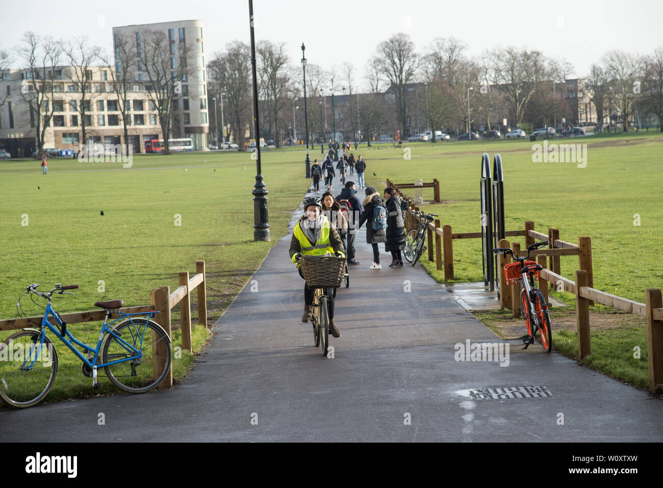 Bikers and pedestrians cross Parker's Piece in central Cambridge 2019 Stock Photo