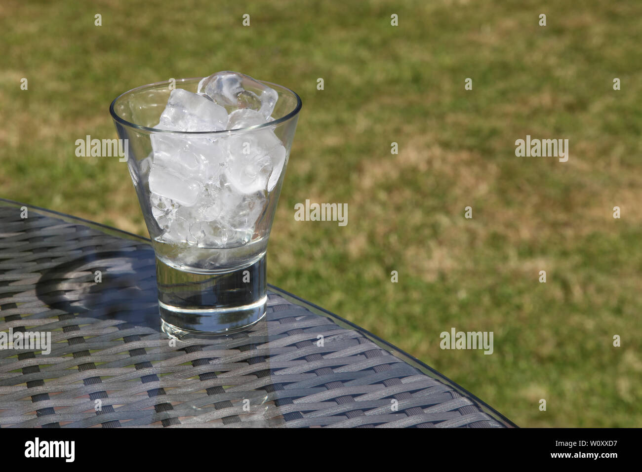 Ice melting concept - Part of a Series of images 1of7 showing glass of ...