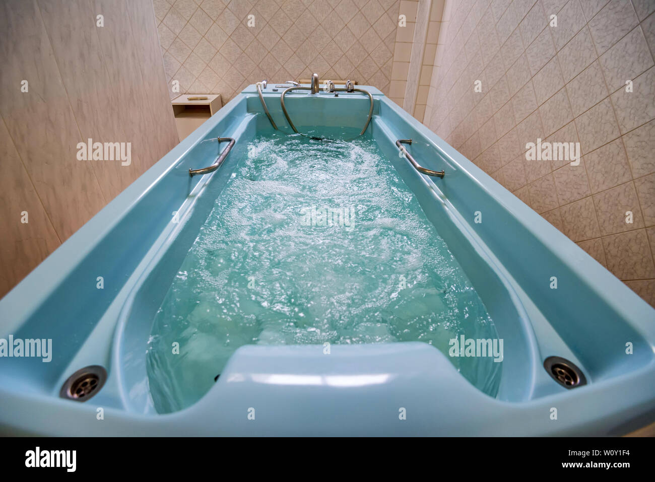 View of modern Jacuzzi bath filled with water turned on Stock Photo Alamy