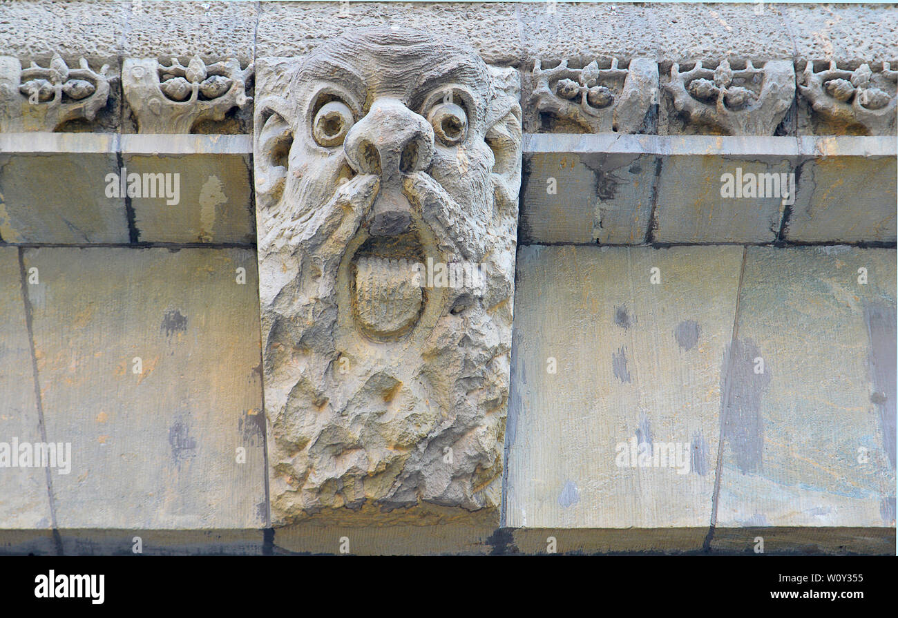Carved troll face, a figure from the Kalevala, on a building in central Helsinki, Finland, part of National Romantic style, nordic art nouveau. Stock Photo