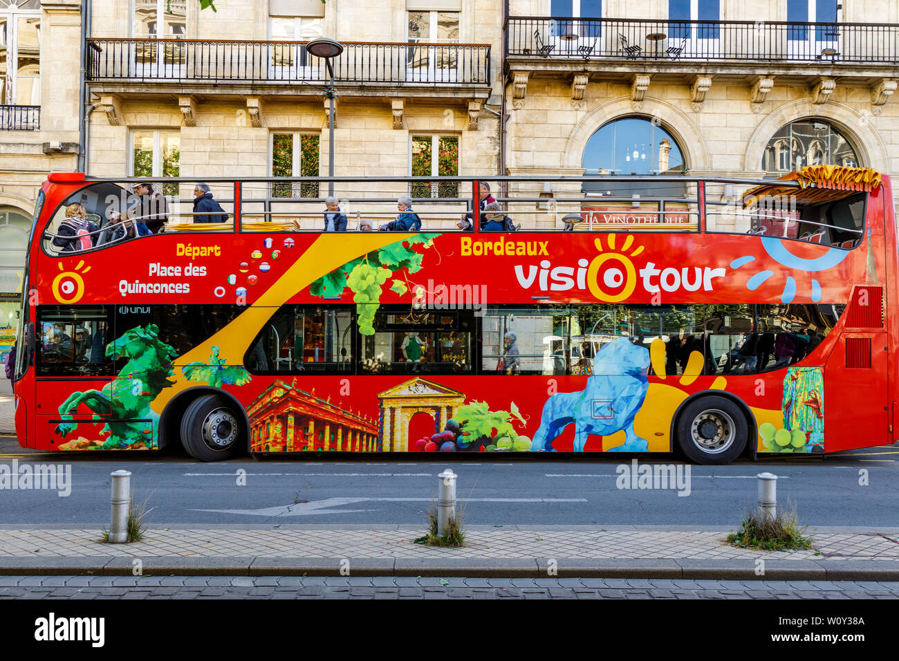Red open topped Hop-On Hop-Off tourist bus in the city of Bordeaux, in the Gironde department in Southwestern France. Stock Photo