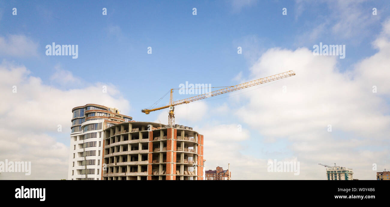 Apartment or office tall building under construction. Brick walls ...