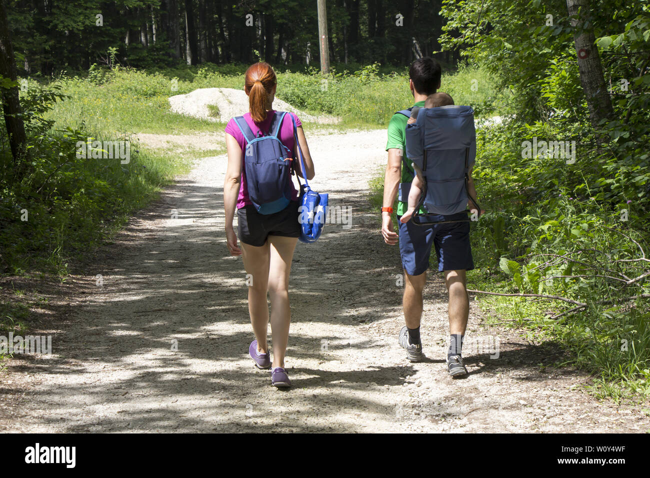 A young couple walks in the woods with a little baby Stock Photo - Alamy