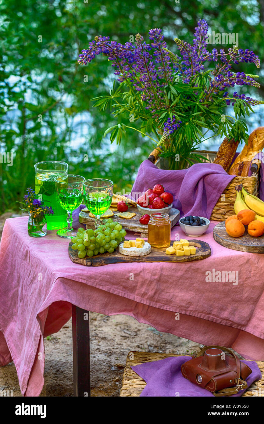 picnic near water at table with flowers in forest different kind of ...