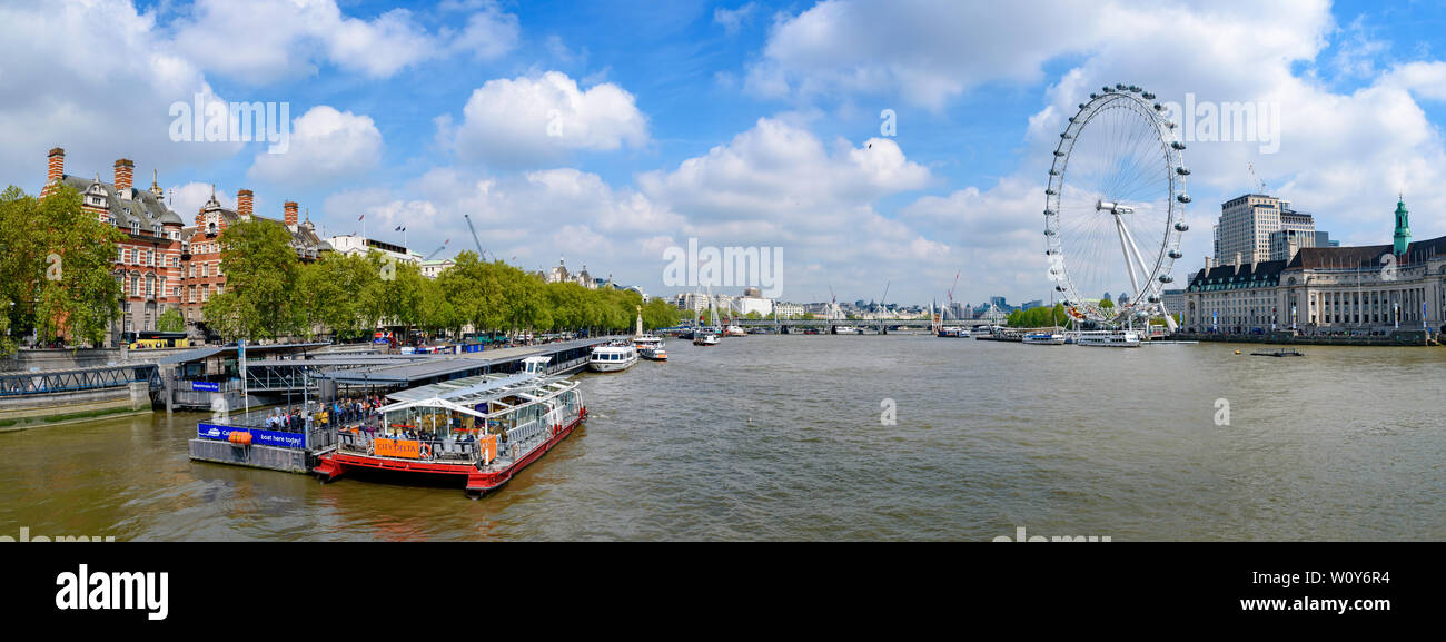 Westminster Millennium Pier on the north bank of the River Thames with London Eye at background in London, United Kingdom Stock Photo