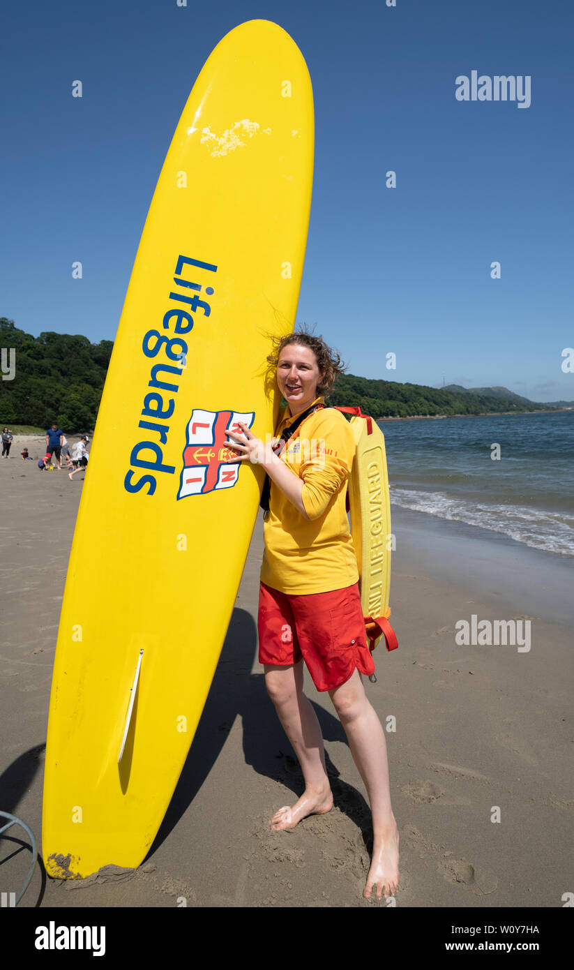 Aberdour, Fife, Scotland, UK. 28 June, 2019. Lifeguard Anna Whyte from Kinghorn in Fife was kept busy at Silver Sands Beach at Aberdour as warm weather and sunshine attracted dozens of people to the seaside. When she is not on duty as a lifeguard , Anna is also a volunteer with the local RNLI lifeboat. Credit: Iain Masterton/Alamy Live News Stock Photo