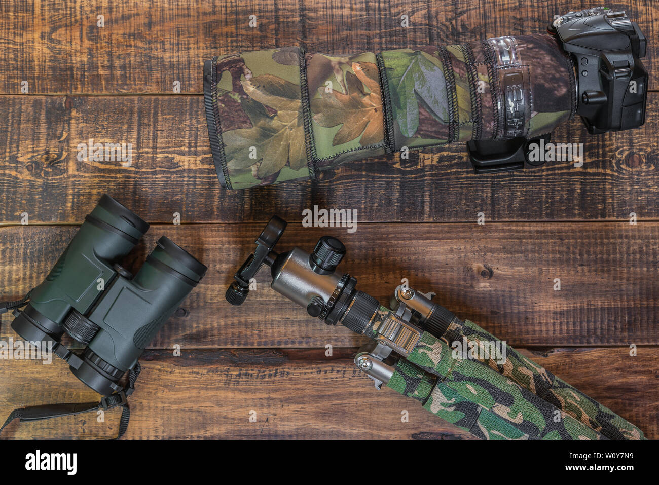 Equipment for the observation and photography of wild fauna on a rustic wooden table Stock Photo