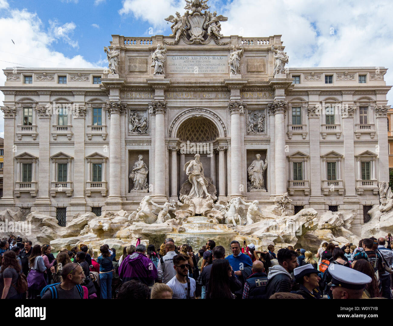 Fontana di Trevi at day with a visiting tourist crowd. Rome, Italy Stock Photo