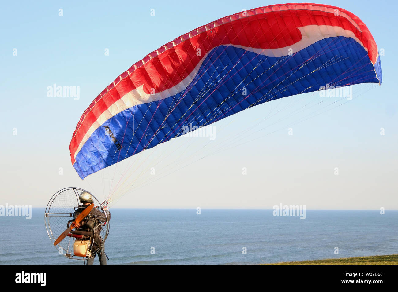 Paramotor  - sport practiced on days with good visibility and stable weather, on the hills of Torres beach, the most beautiful in Rio Grande do Sul. Stock Photo