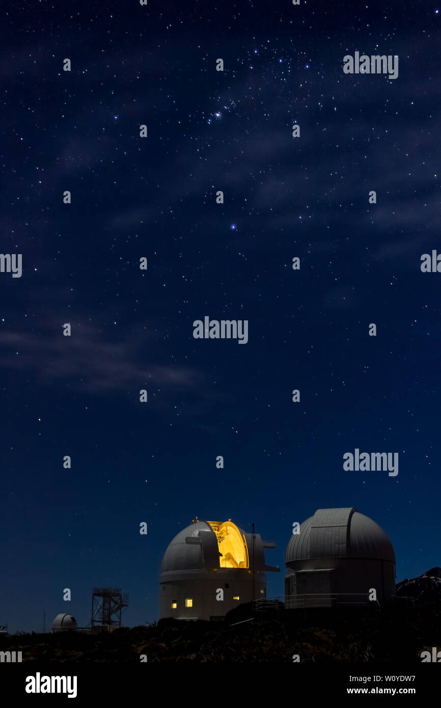 Beautiful image of telescopes working at night illuminated by the Moon