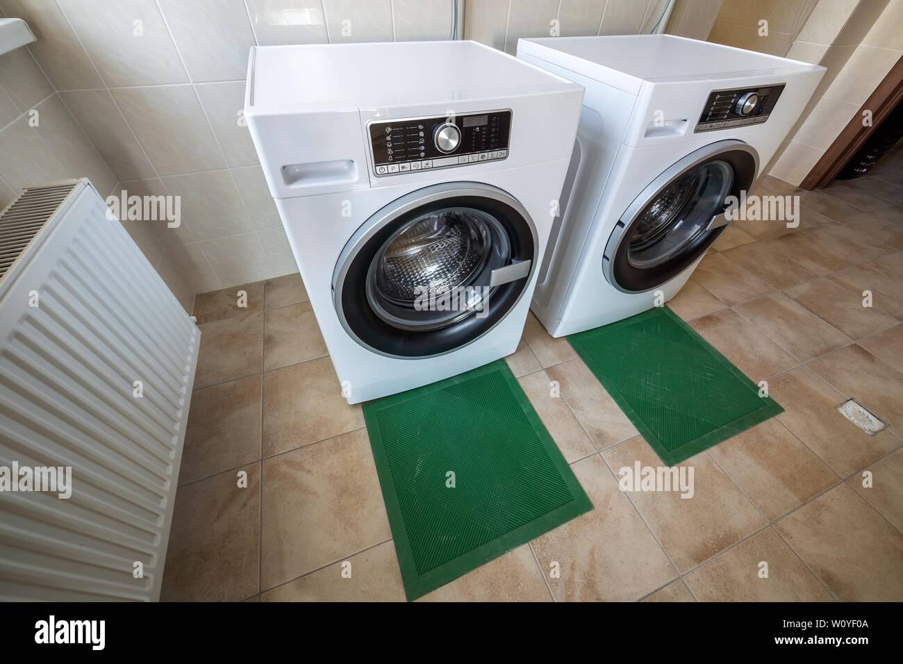 Modern New Industrial Washing Machines In Clean Tiled