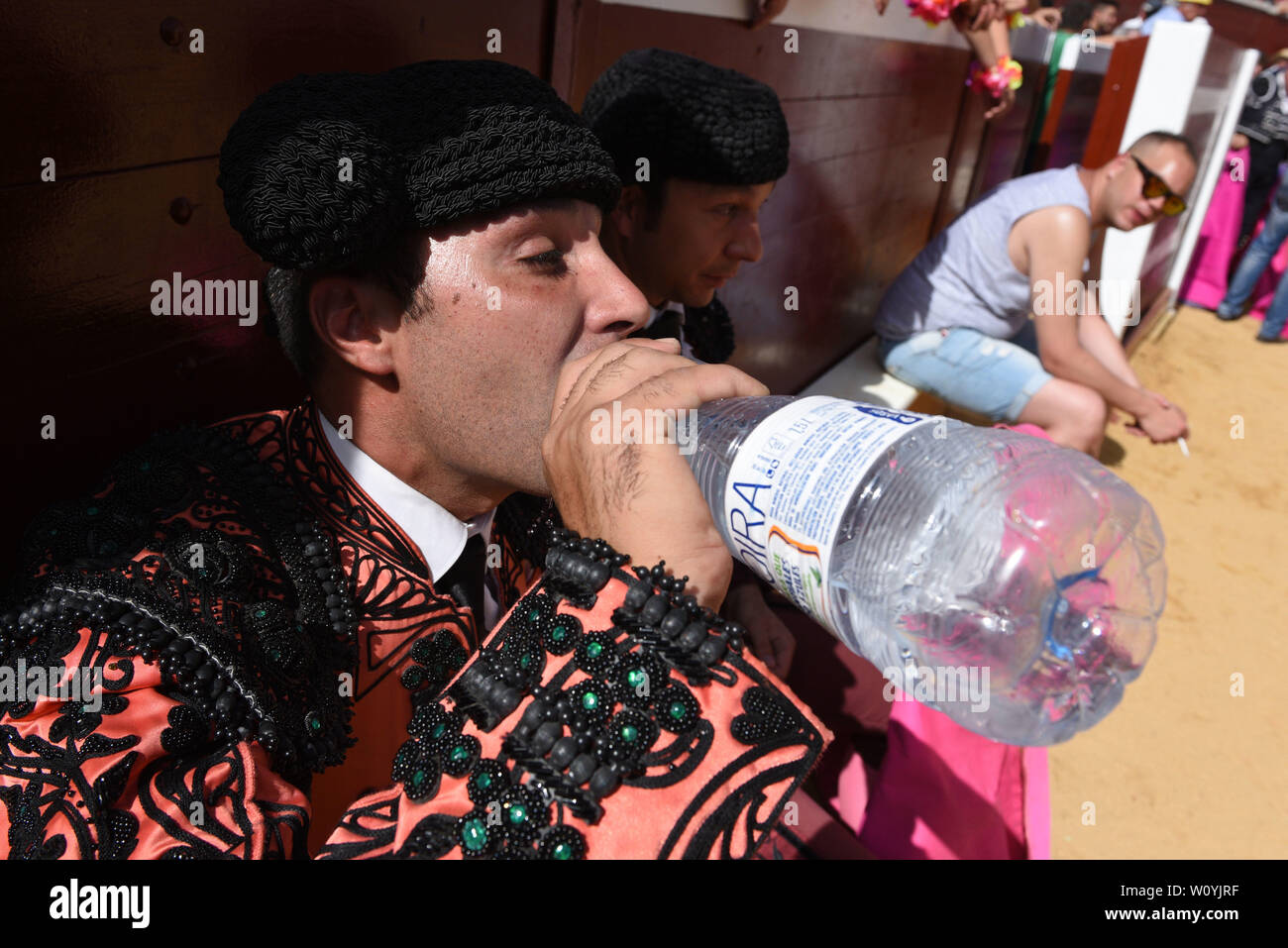 A Spanish bullfighter drinks water as temperatures reached 36º degrees Celsius during the Viernes de Toros Celebration in Soria.The first heat wave of summer, which has claimed lives continues in Spain. Spanish's weather agency AEMET forecasts show today is set to be the worst day for severe hot weather with temperatures up to 42C in several regions. Stock Photo