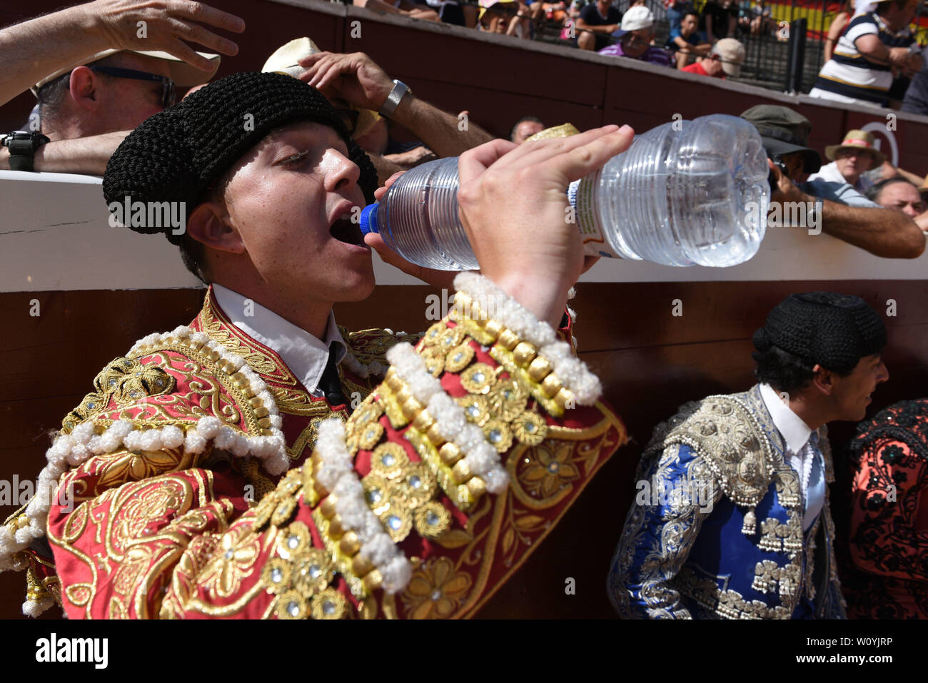 A Spanish bullfighter drinks water as temperatures reached 36º degrees Celsius during the Viernes de Toros Celebration in Soria.The first heat wave of summer, which has claimed lives continues in Spain. Spanish's weather agency AEMET forecasts show today is set to be the worst day for severe hot weather with temperatures up to 42C in several regions. Stock Photo