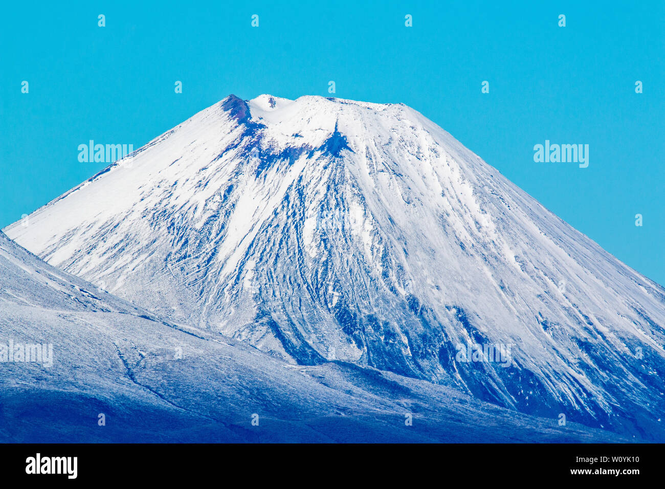 Volcanic cone covered in snow Stock Photo