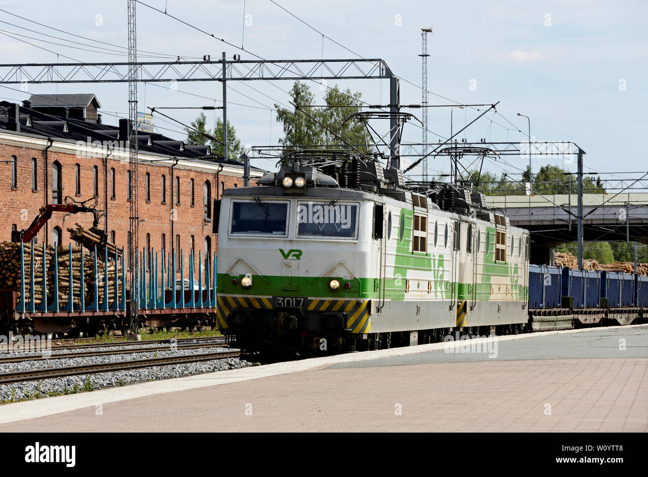Hameenlinna, Finland 06/12/2019 At Hameenlinna railway station green white VR-train passing by with a lot of railway carriage Stock Photo
