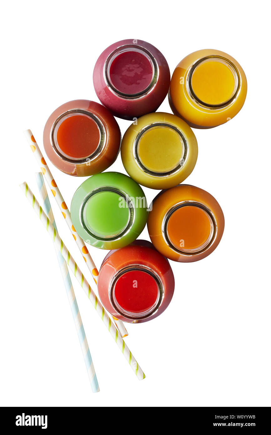 Several isolated glass jars without caps filled with different colors of blended juices on white surface Stock Photo