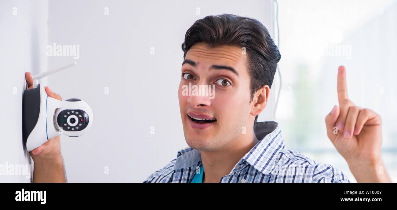 Man installing surveillance CCTV cameras at home Stock Photo Alamy