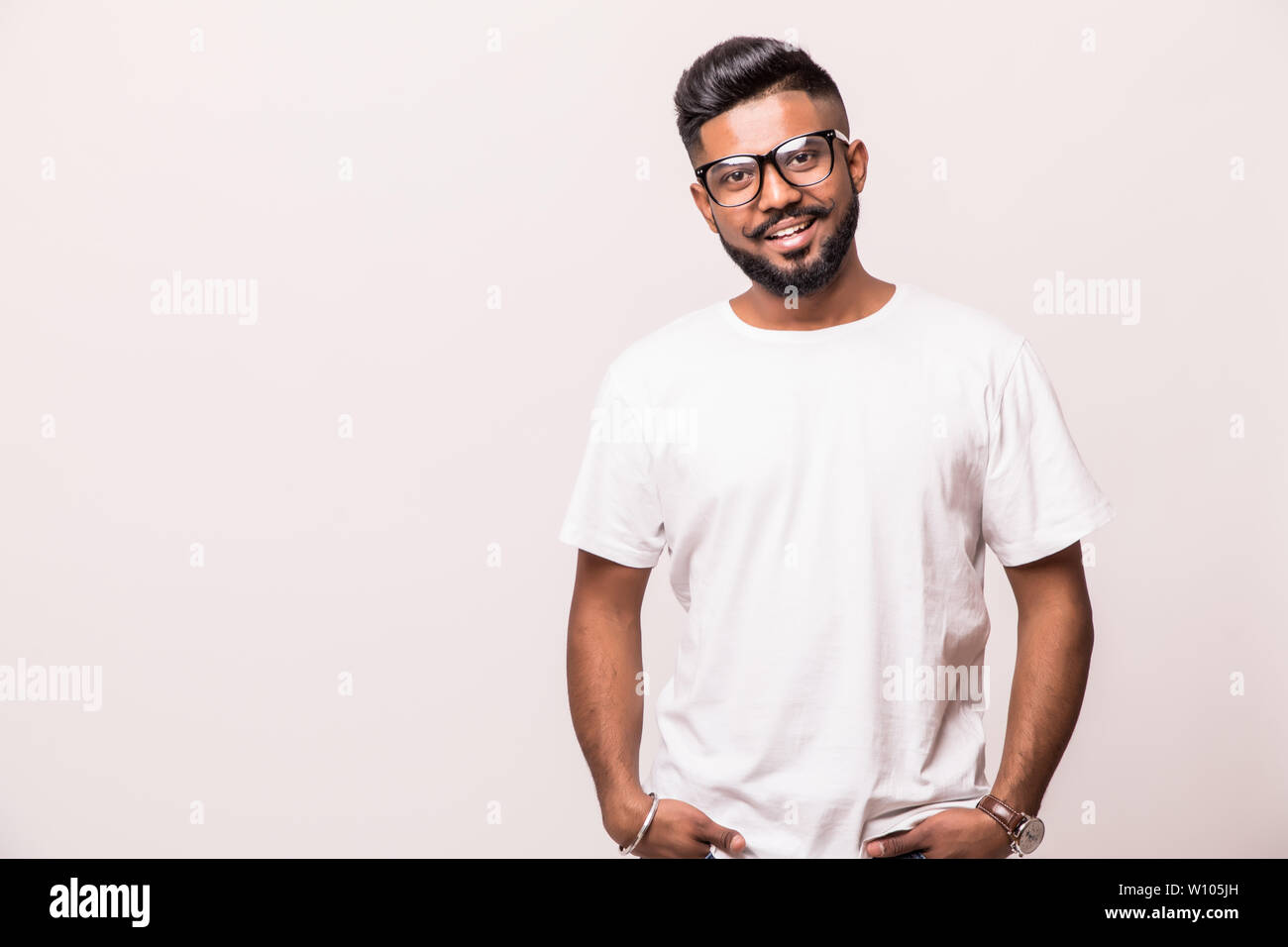 Young indian man in eyesglasses standing isolated on white background Stock Photo