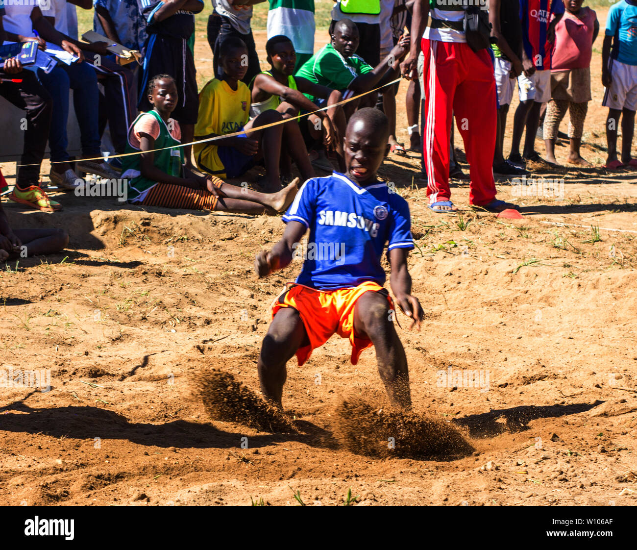 High school girl landing after a long jump at the School Sports Games Festival in Chinhamapere Secondary School Stock Photo