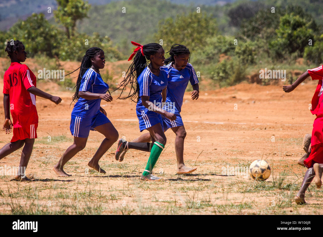 High school girls playing football in their physical education class match Stock Photo