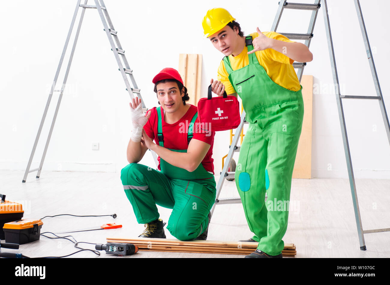 Injured worker and his workmate Stock Photo
