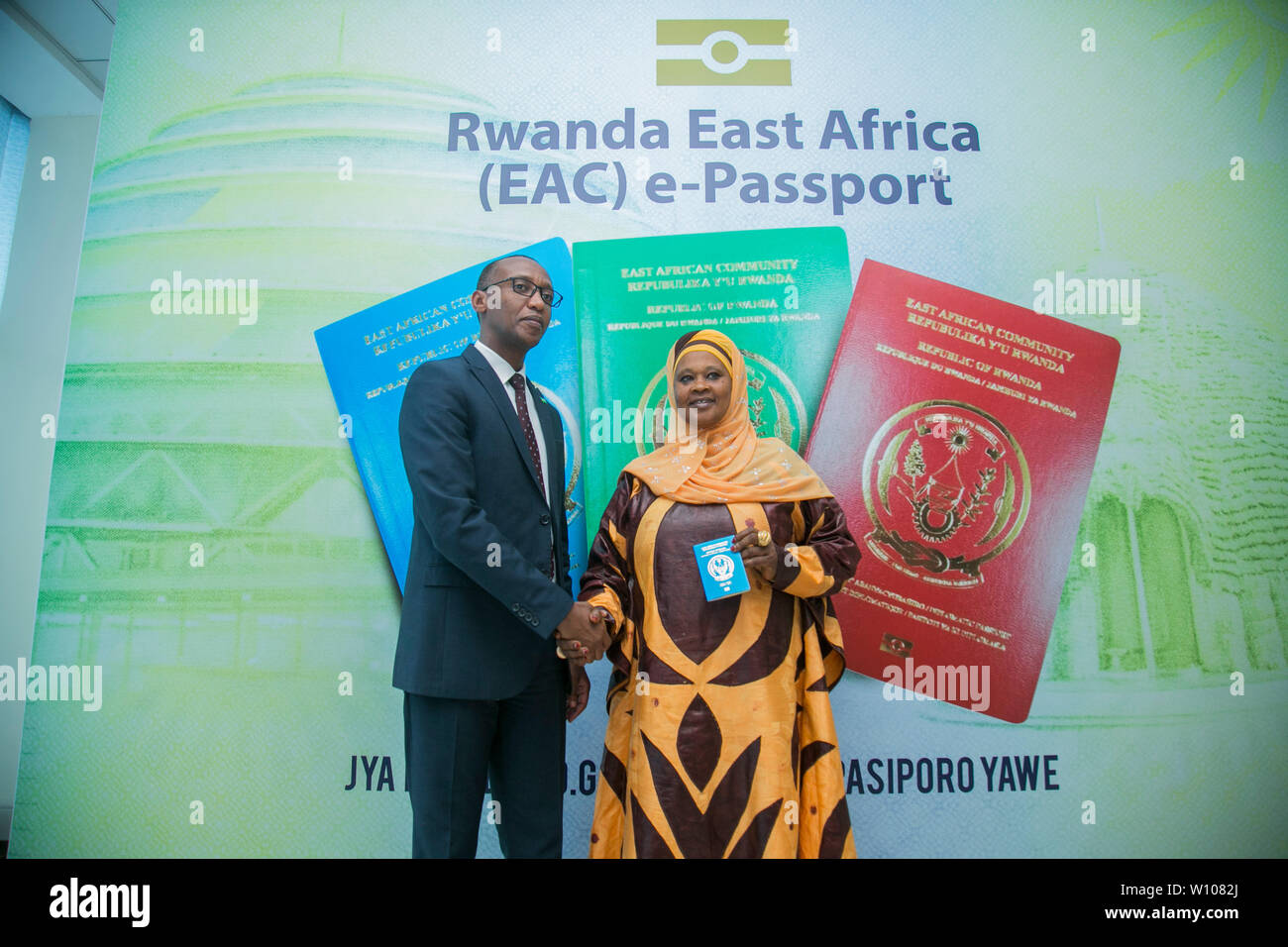 Kigali, Rwanda. 28th June, 2019. Francois Regis Gatarayiha (L), director general of Directorate General of Immigration and Emigration of Rwanda, presents a Rwanda East Africa e-passport to one of the first users in Kigali, capital city of Rwanda, on June 28, 2019. Rwanda has begun issuing the East Africa e-passport in line with the country's commitment to promote regional integration as envisioned by East African Community (EAC) partner states, an immigration official announced Friday. Credit: Cyril Ndegeya/Xinhua/Alamy Live News Stock Photo