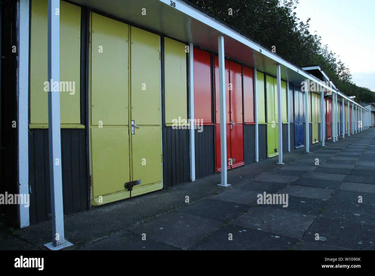 Colourful beach chalets Royal Parade Filey North Yorkshire Stock Photo