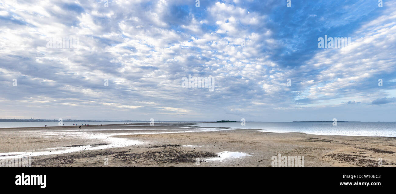 Beach leading out to Kings Island at low tide Stock Photo