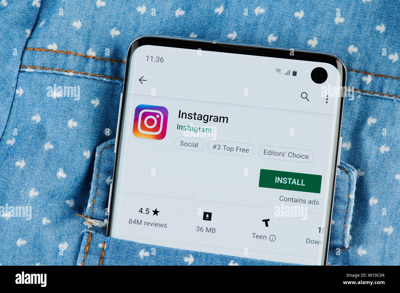 New york, USA - June 28, 2019: Installing instagram  application on smartphone screen close up view in shirt pocket Stock Photo
