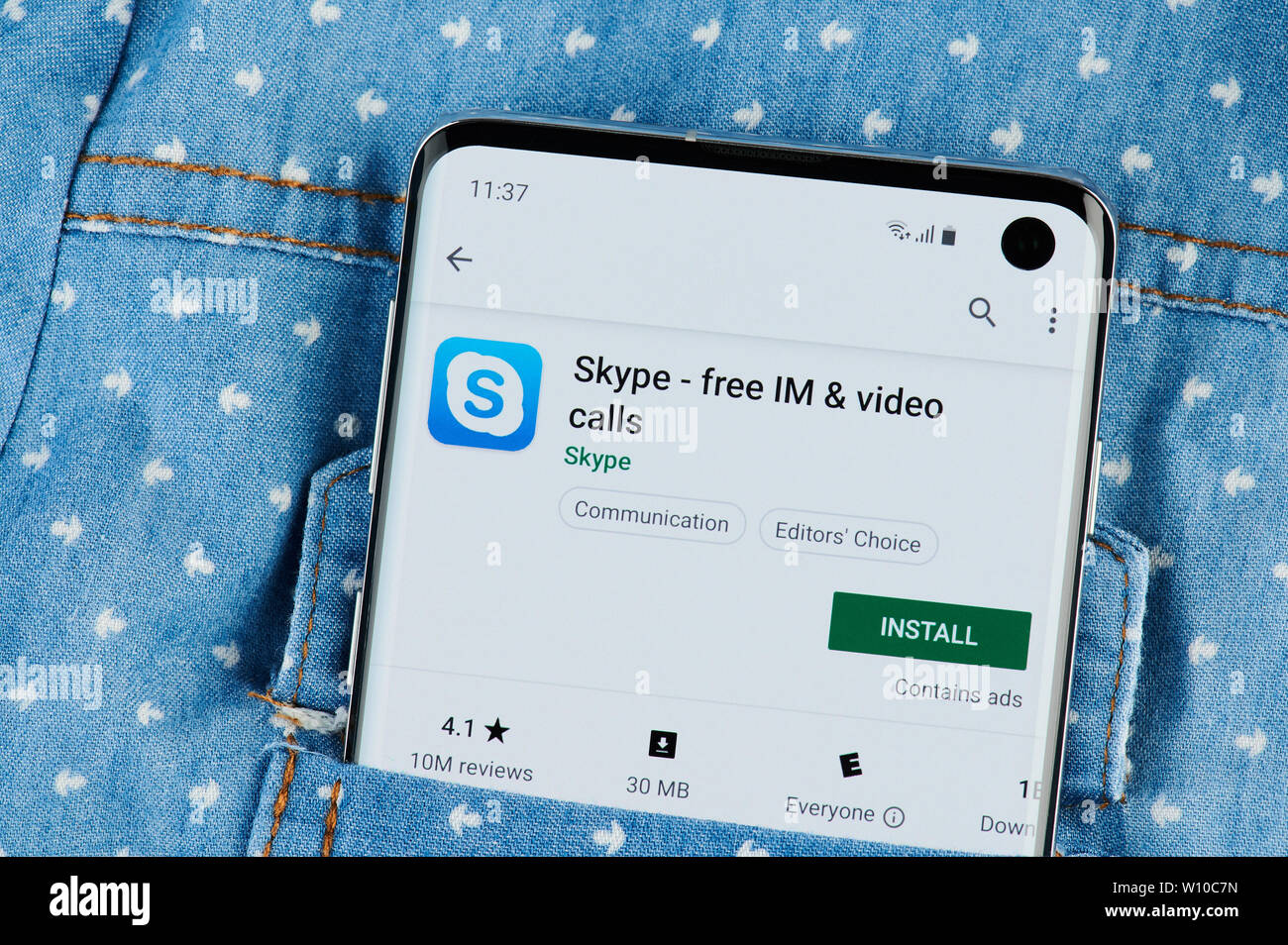 New york, USA - June 28, 2019: Installing skype application on smartphone screen close up view in shirt pocket Stock Photo