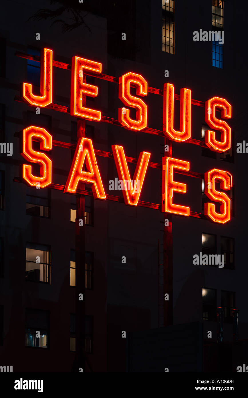 Jesus Saves sign at night, in downtown Los Angeles, California Stock