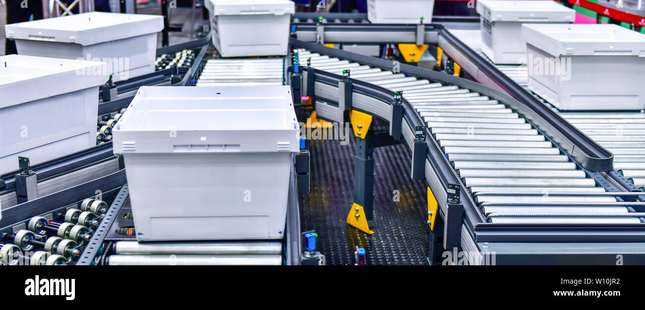 White plastic box on conveyor belt.parcels transportation system concept Stock Photo
